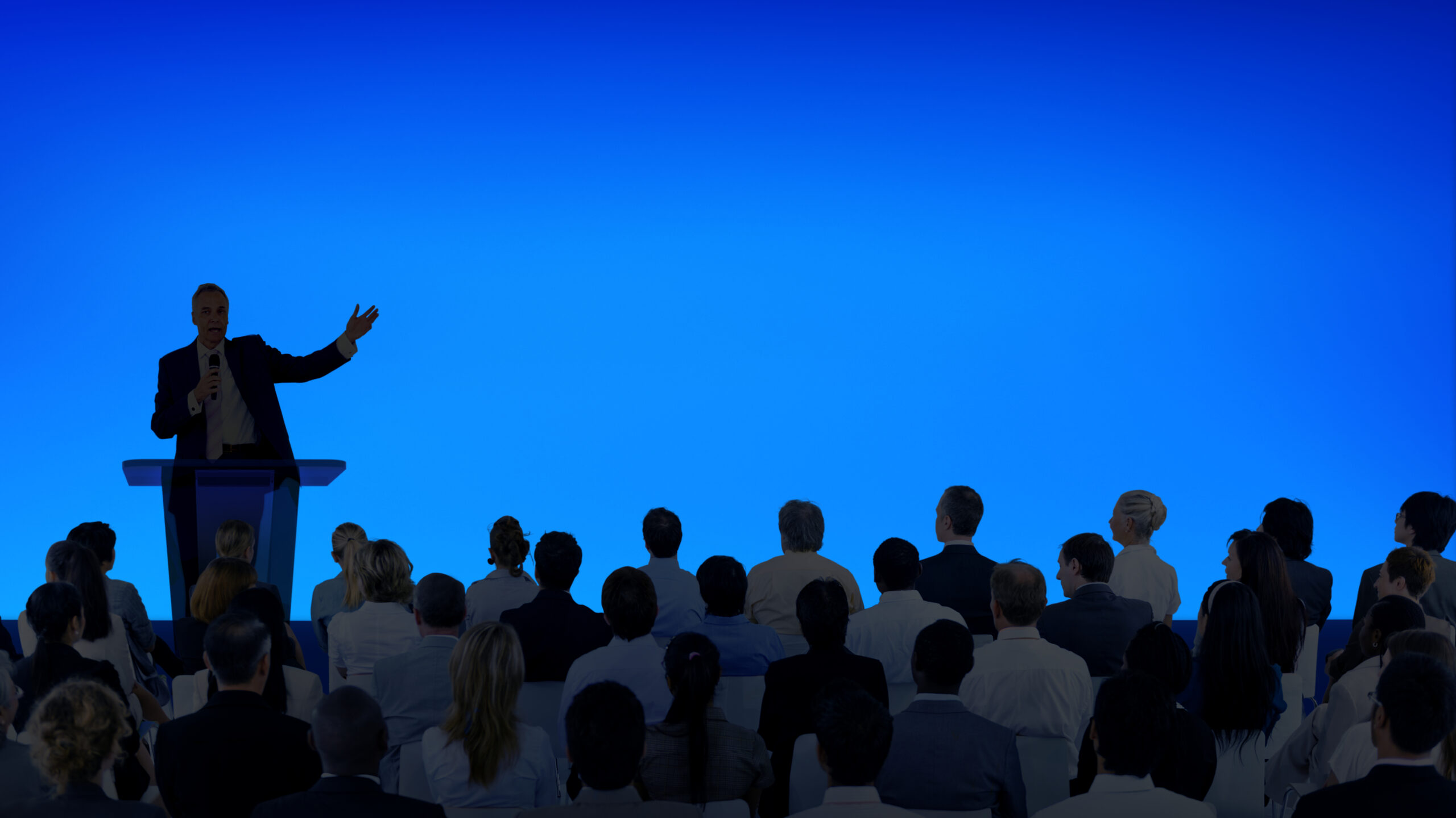 Man giving business presentation in front of huge crowd